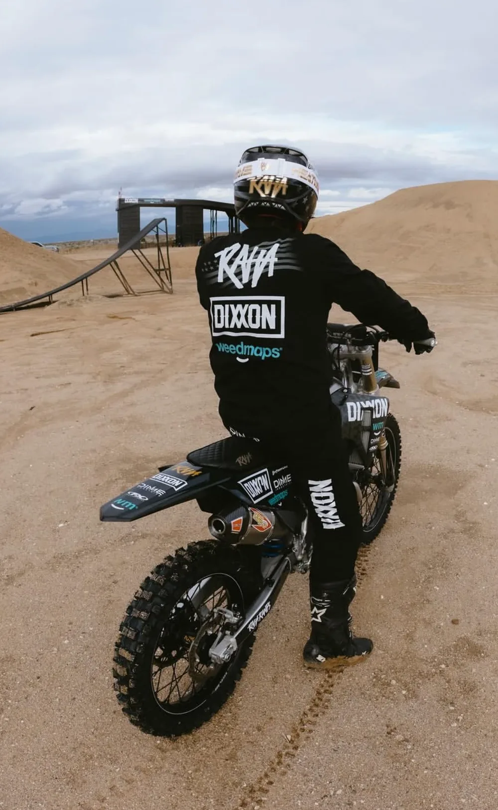 Colby on the dirt bike seen from behind in the jersey